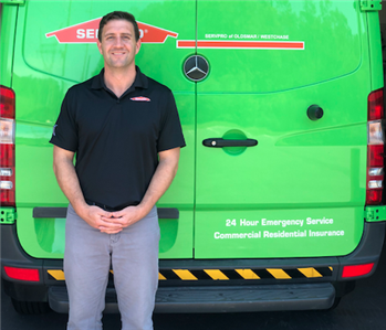 Male SERVPRO Employee Standing in front of a van