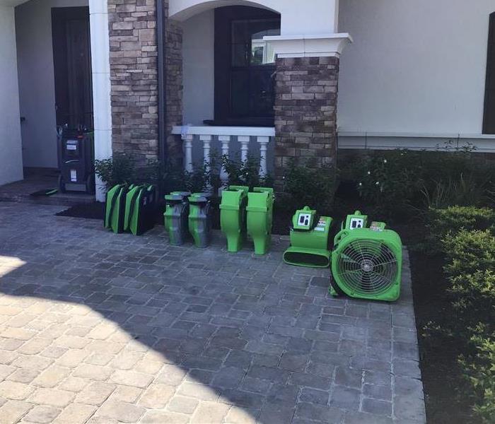 green drying equipment sitting outside of a building 